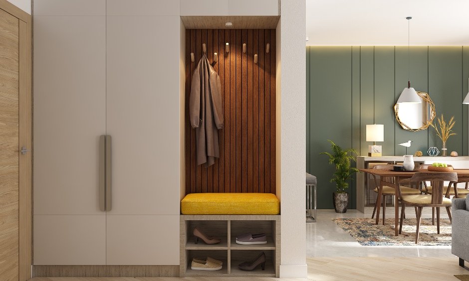 2bhk flat design with open shelves beneath the cabinet to keep your shoes and a tiny seating arrangement