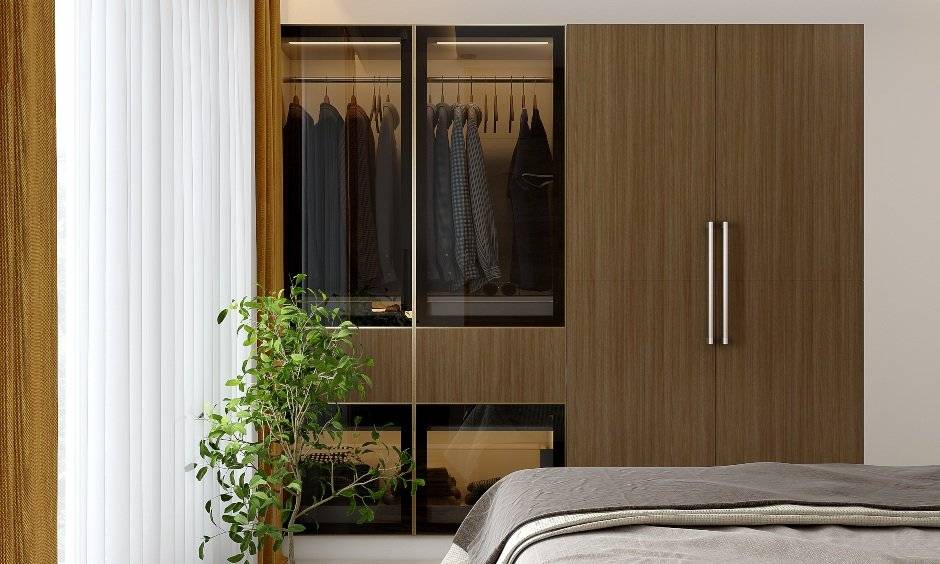 2bhk home wardrobe with wooden doors on one side and a glass front add display space