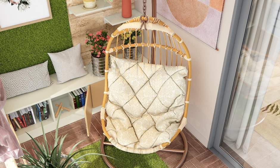 Balcony design with a single seater wicker swing and cushion