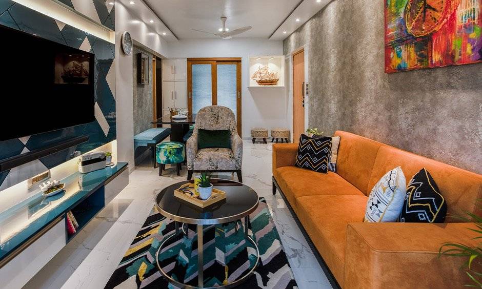 A blue living room with dining table designed by best budget interior designers in mumbai