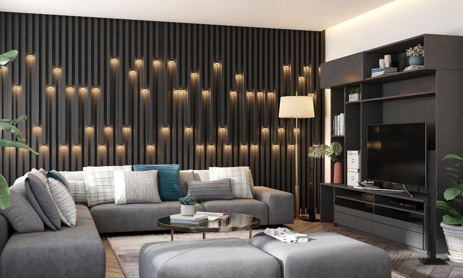 Black and grey living room with bold walls, grey sofa, and quirky pendant lights.