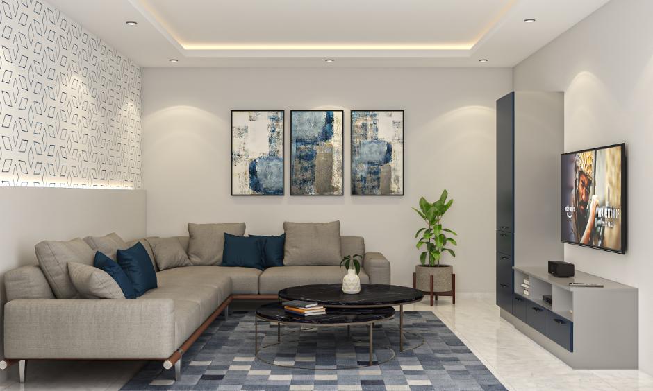 Modern minimalist living room uses navy blue and grey tones for a calm, balanced, stylish space.