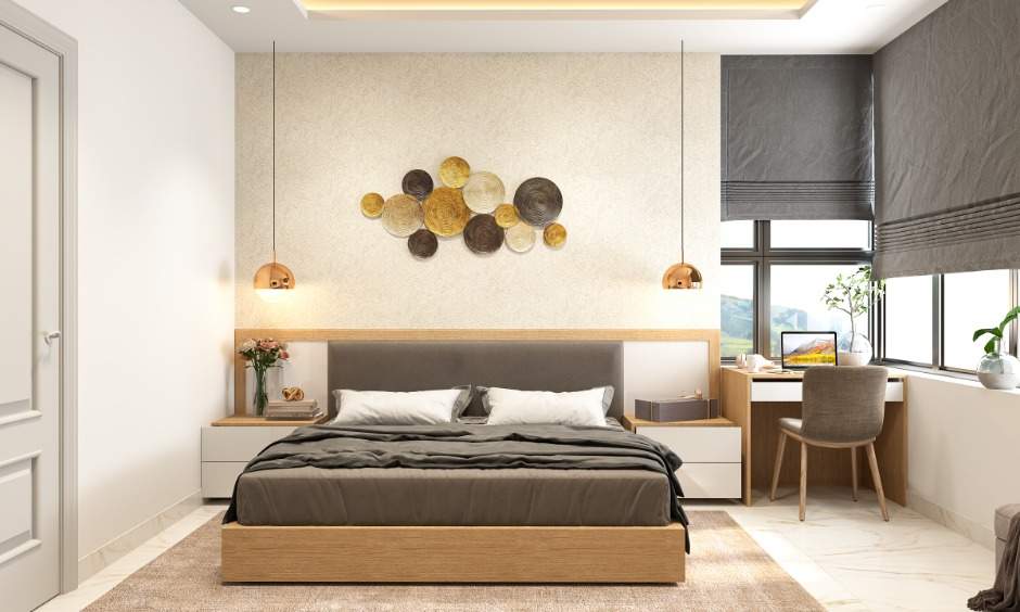 A classy bedroom in 1 bhk home design with a bed and a small study nook gives the interior edge