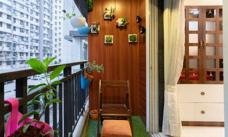 Comfortable wooden patio chair with a footrest by interior architects in mumbai
