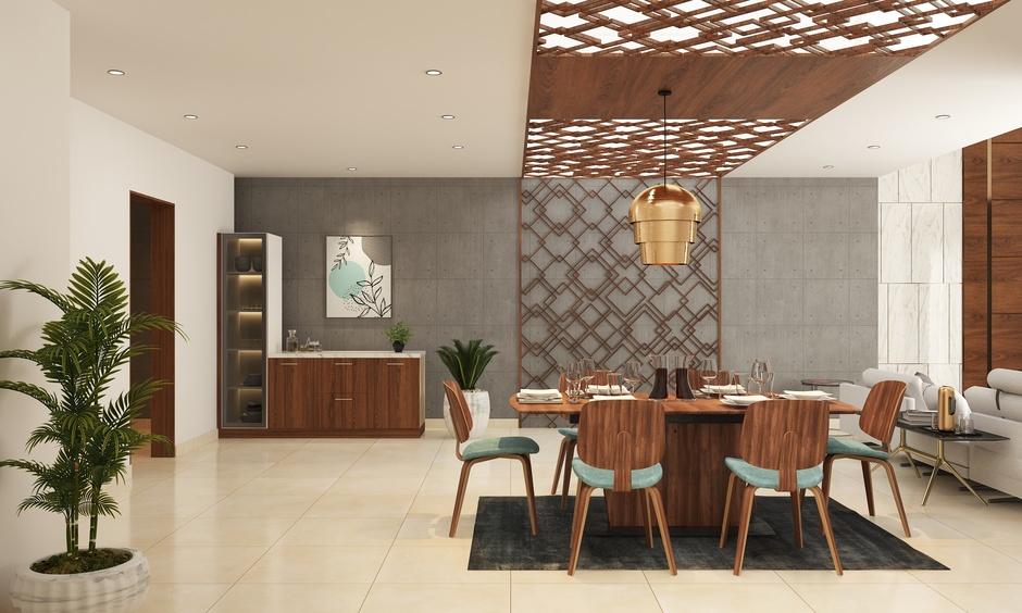 Dining room with concrete grey walls, offering a contemporary vibe paired with warm wood and metal accents.