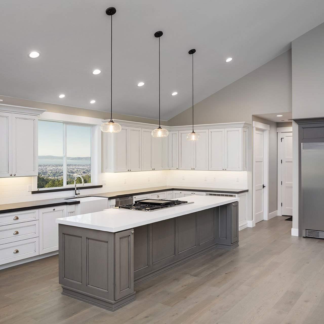 Contemporary modular kitchen design with wooden cabinets and white countertops