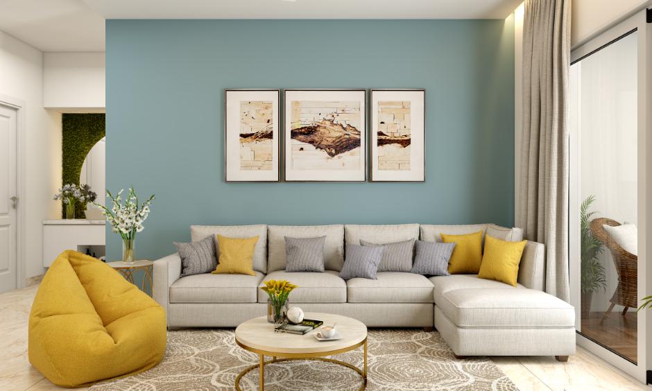 Minimalist living room uses light tones and soft blue with mustard accents for a cozy, cheerful feel.