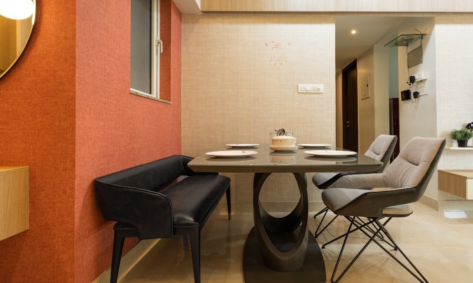 Dining area has a sleek dining table with designer chairs designed by top interior designers in mumbai