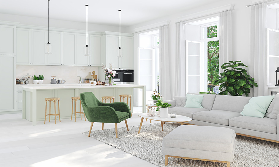 Bright dog-friendly living room with pastel tones, green chair, natural light, and open layout.