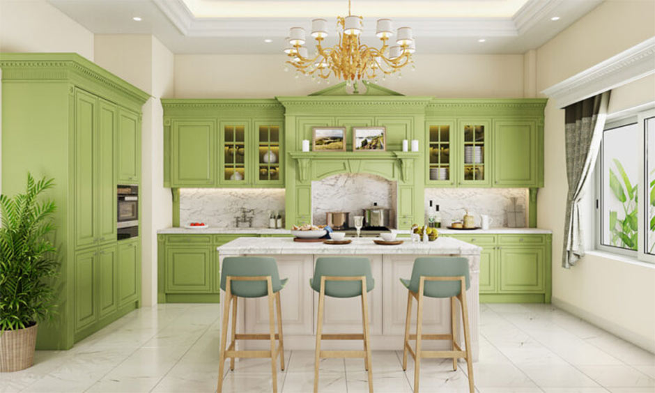 Elegant green kitchen with marble counters, chandelier, and island seating