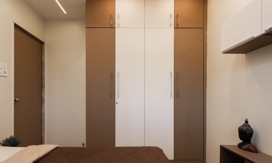 Floor-to-ceiling wardrobe is in a brown and white matte finish in Ulwe, Navi Mumbai