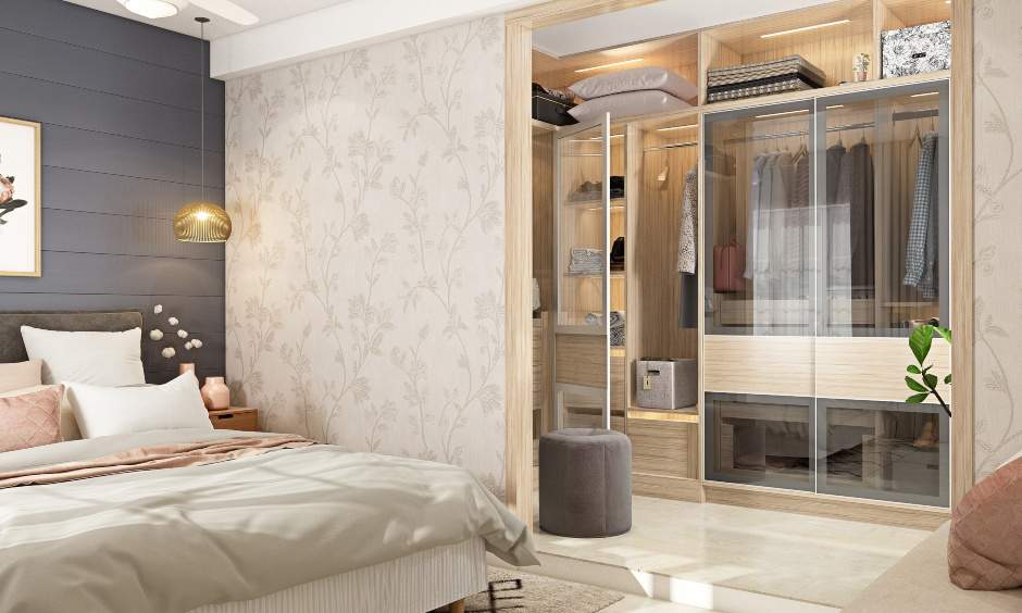 Floor to ceiling wardrobe with glass shutters look and feel premium in this modern bedroom