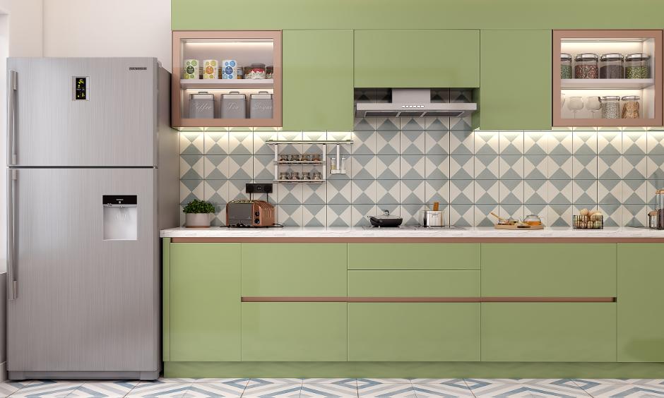 Modern kitchen design using HDHMR sheet cabinets in green with triangle pattern tiles and a white countertop