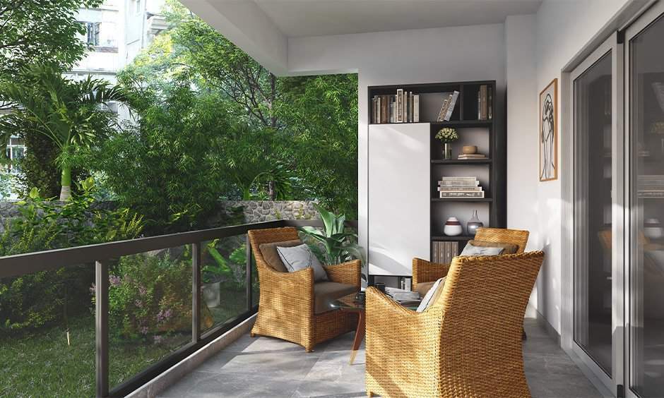 Ground floor balcony design with grey vitrified tiles and cane furniture