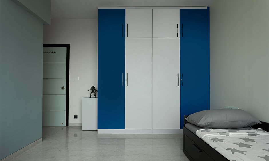 Interior design for home in mumbai where the kid's room is designed in blue and white to lend subtle playfulness to the space