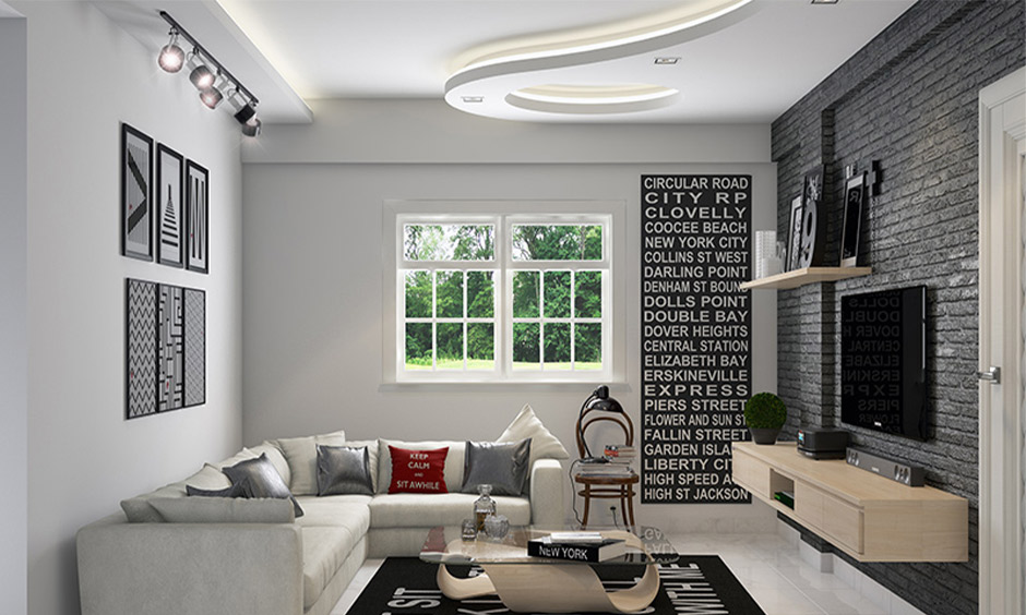 Living room with elegant POP ceiling design featuring curved layers and integrated soft lighting.
