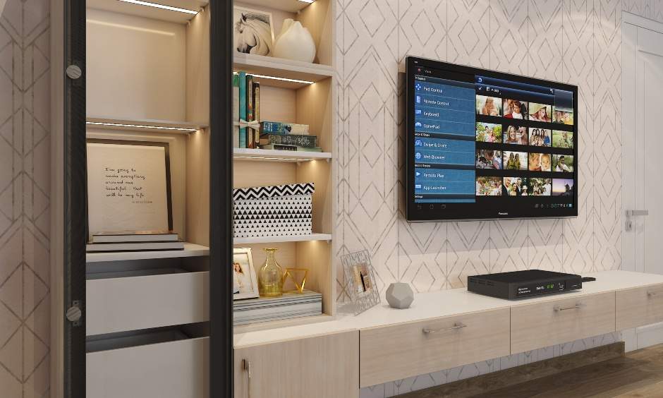 Living room TV cabinet extends into a glass unit with in-built lighting for displaying decor elements