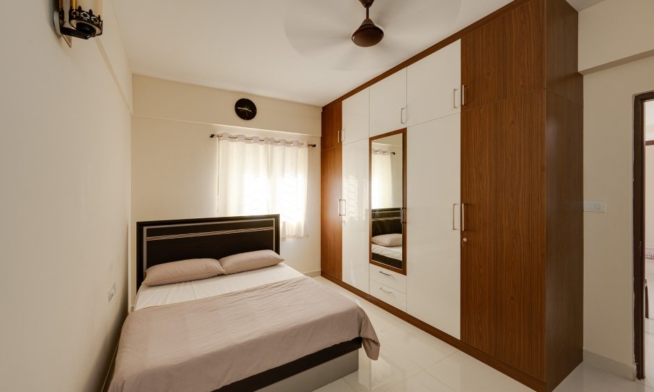 Master bedroom with spacious floor-to-ceiling wardrobe in a 3 BHK flat