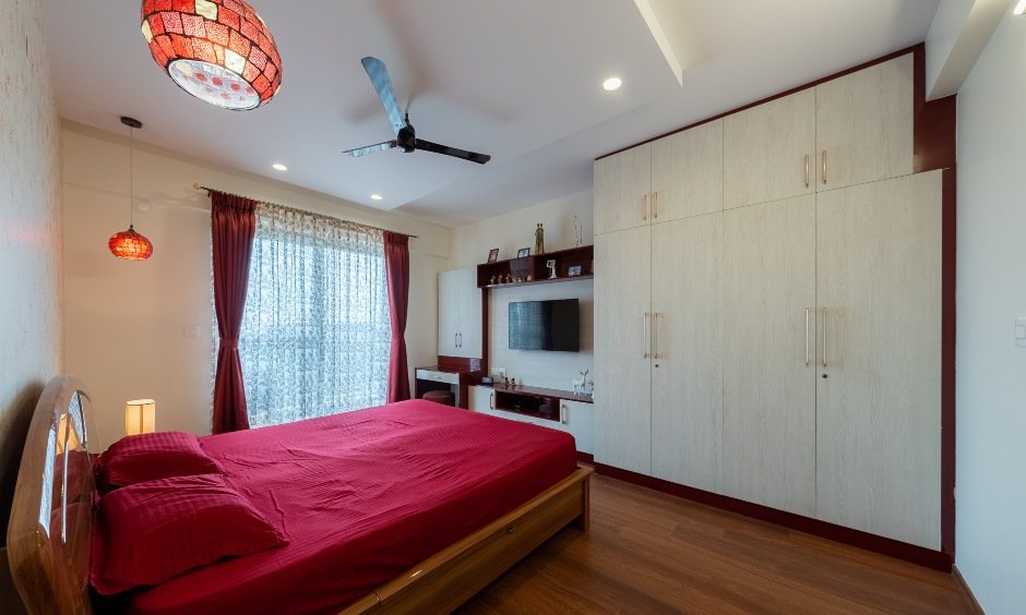 Master bedroom with a floor-to-ceiling wardrobe in Whitefield with a white laminate finish