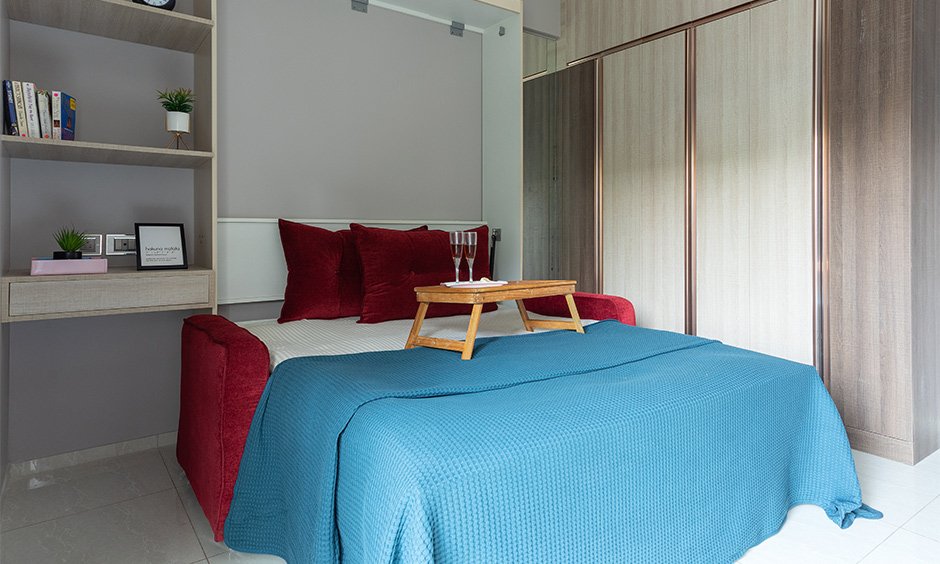 Residential interior designers in mumbai with a murphy bed and a floor-to-ceiling wardrobe with a study unit attached to the bed