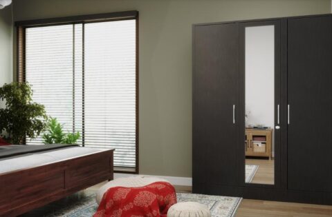 Three-door steel wardrobe with a mirror in a contemporary bedroom interior