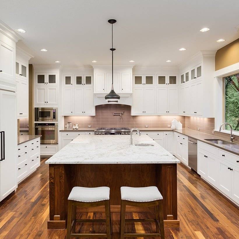 U shaped kitchen interior design has a large island placed at it center in line with the cabinetry