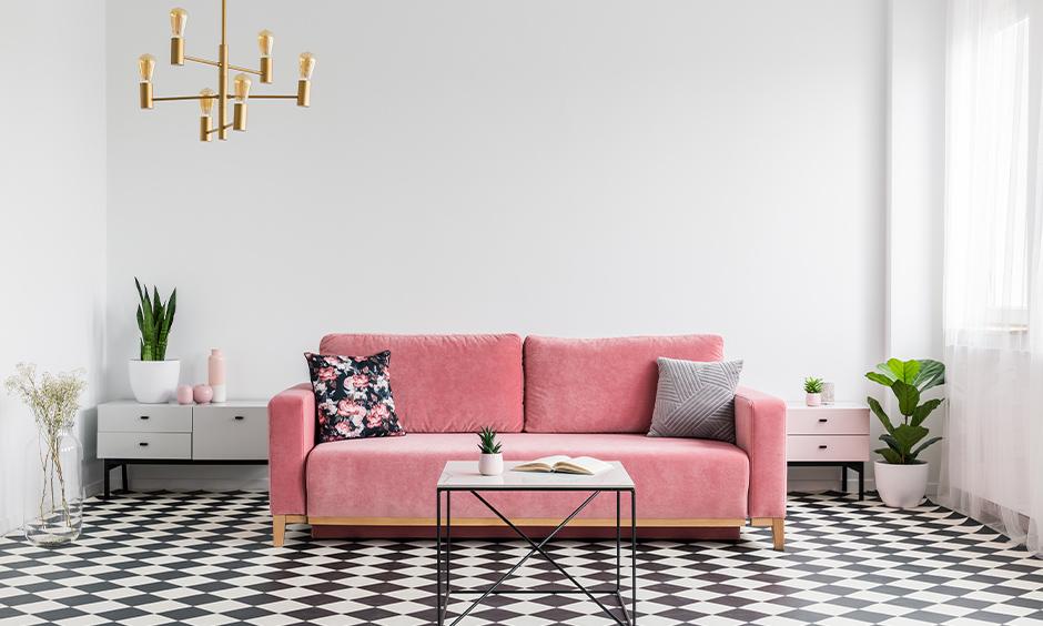 Black and white tiled living room floor with pink sofa for a chic design style