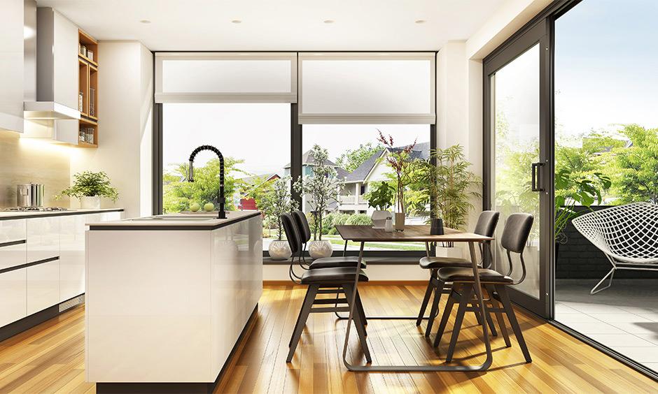 Full-height glass sliding door dividing the kitchen and dining area for a brighter, open layout